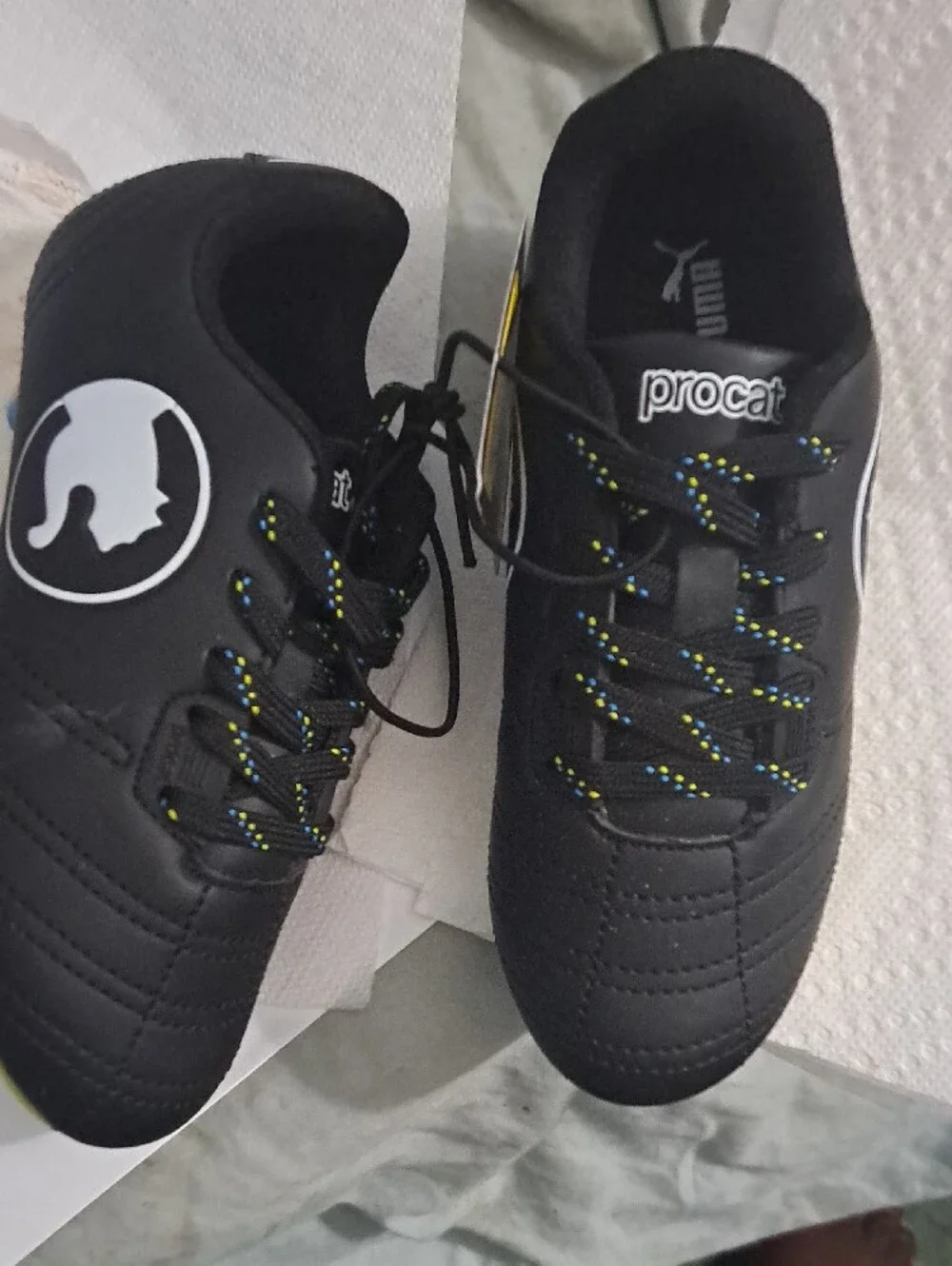 Puma Kids Black Soccer Cleats with Yellow Sole and Blue Studs